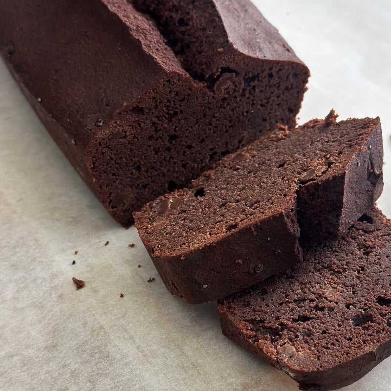 Gluten free Keto Chocolate loaf cake with slices on a light surface